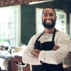 Barber smiling representing beauty and wellness New Year's resolutions